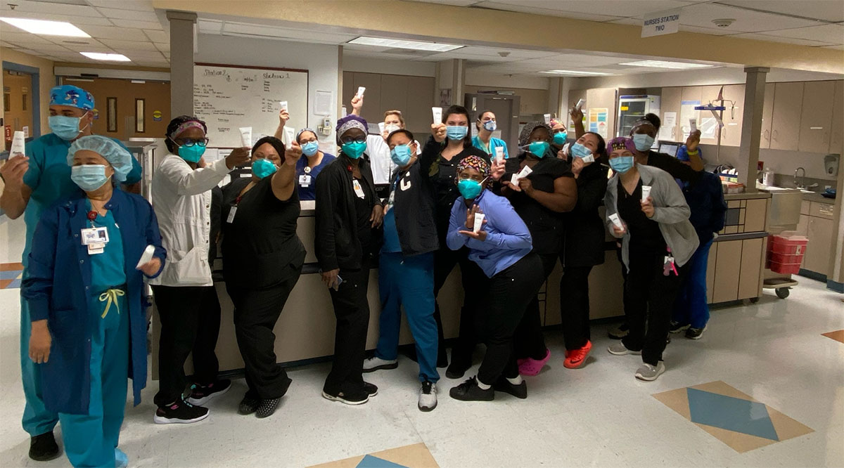 Health care workers at Starr County Memorial Hospital in Rio Grande City, Texas, react after receiving 4,000 bottles of Merci Handy hand sanitizer donated by the company. The donation was coordinated through Get Us PPE. Credit: Starr County Memorial Hospital